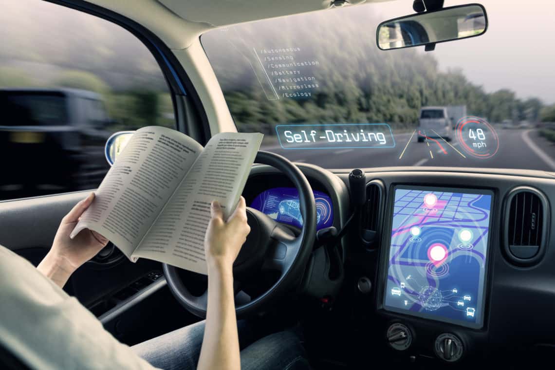 cockpit of autonomous car. a vehicle running self driving mode and a woman driver reading book.