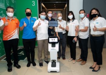 Advisers to East Coast GRC, Deputy Prime Minister Heng Swee Keat, Minister of State Tan Kiat How, and Ms Jessica Tan, and other guests outside the next-generation lift with Temi-Bot.