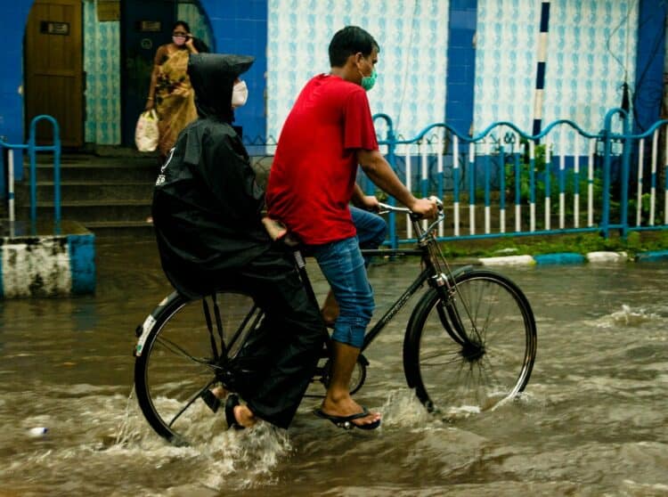 Photo by Biplab Sau: https://www.pexels.com/photo/riding-a-bike-in-the-flood-10872328/
