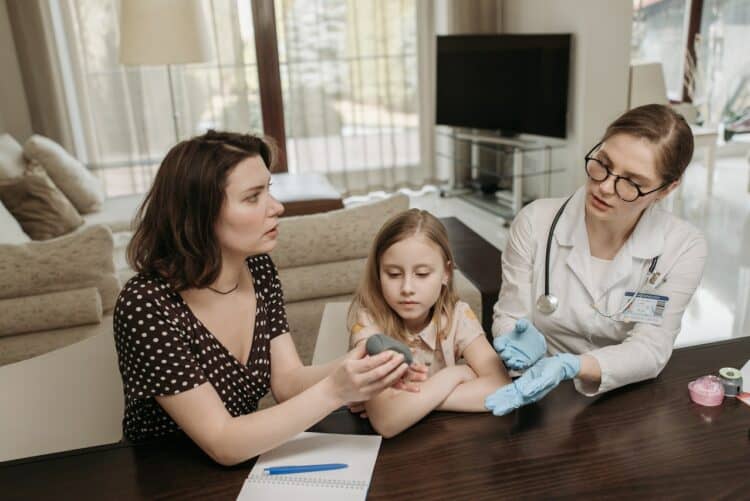 Photo by Pavel Danilyuk: https://www.pexels.com/photo/mother-and-doctor-having-a-conversation-while-holding-gray-device-7653310/