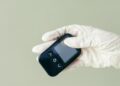 Photo by Mikhail Nilov: https://www.pexels.com/photo/a-person-in-latex-gloves-holding-a-glucometer-device-8669879/