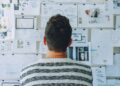 Photo by Startup Stock Photos from Pexels: https://www.pexels.com/photo/man-wearing-black-and-white-stripe-shirt-looking-at-white-printer-papers-on-the-wall-212286/