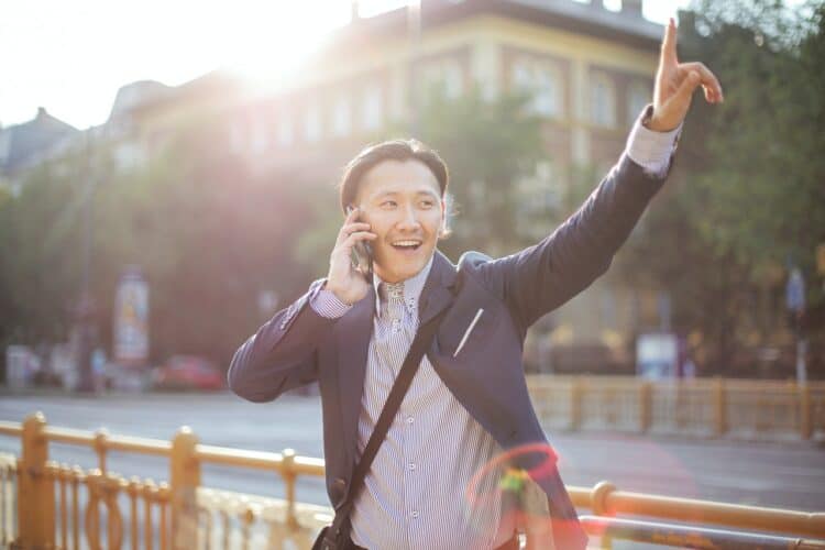 Photo by Andrea Piacquadio: https://www.pexels.com/photo/cheerful-asian-businessman-chatting-on-phone-and-hailing-cab-3760814/
