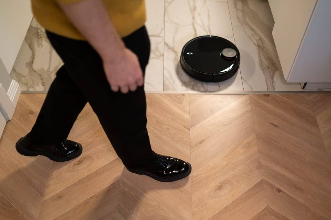 Photo by cottonbro studio: https://www.pexels.com/photo/person-walking-near-a-robotic-vacuum-cleaner-on-marble-floor-6856823/