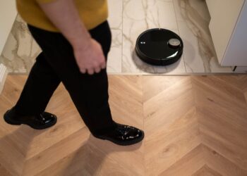 Photo by cottonbro studio: https://www.pexels.com/photo/person-walking-near-a-robotic-vacuum-cleaner-on-marble-floor-6856823/