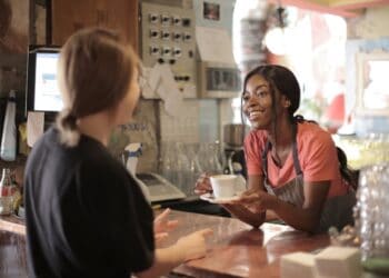Photo by Andrea Piacquadio: https://www.pexels.com/photo/delighted-black-female-barista-serving-coffee-in-cup-in-cafe-3796810/