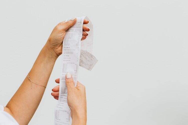 Photo by Karolina Kaboompics: https://www.pexels.com/photo/woman-holding-a-receipt-4959907/