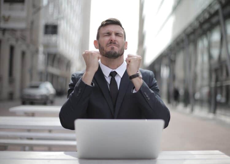 Photo by Andrea Piacquadio: https://www.pexels.com/photo/man-in-black-suit-sitting-on-chair-beside-buildings-3778966/