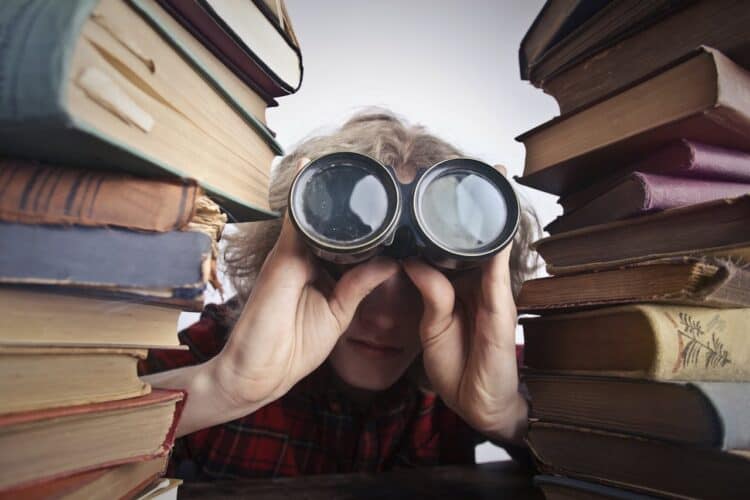 Photo by Andrea Piacquadio: https://www.pexels.com/photo/man-using-binoculars-in-between-stack-of-books-3769697/