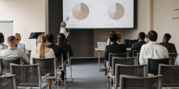 Photo by Pavel Danilyuk: https://www.pexels.com/photo/people-on-chairs-looking-at-presentation-at-business-conference-8761520/