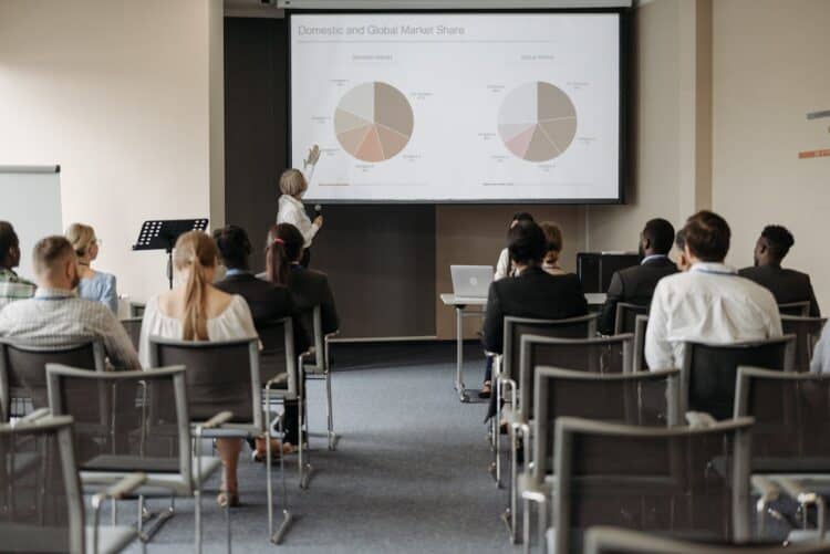 Photo by Pavel Danilyuk: https://www.pexels.com/photo/people-on-chairs-looking-at-presentation-at-business-conference-8761520/