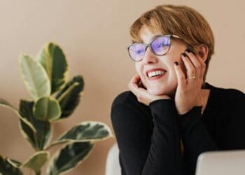 Photo by Photo By: Kaboompics.com: https://www.pexels.com/photo/cheerful-woman-working-on-laptop-and-smiling-4467683/