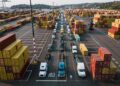 Photo by Kelly    : https://www.pexels.com/photo/parked-trucks-and-cargo-containers-on-port-13766346/