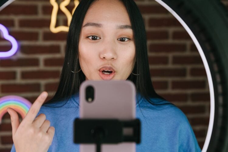 Photo by Ivan Samkov: https://www.pexels.com/photo/a-woman-recording-herself-with-a-smartphone-7676409/