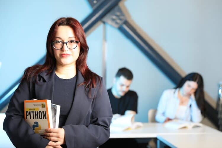 Photo by Yusuf Timur Çelik: https://www.pexels.com/photo/young-professional-holding-python-book-in-class-32213227/