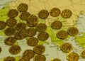 Photo by Q L: https://www.pexels.com/photo/golden-coins-on-map-background-29859663/