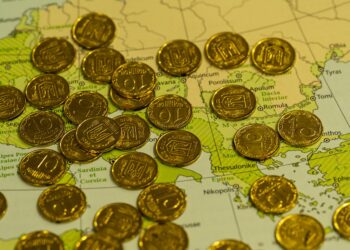 Photo by Q L: https://www.pexels.com/photo/golden-coins-on-map-background-29859663/