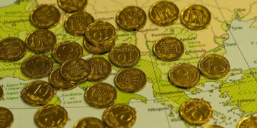 Photo by Q L: https://www.pexels.com/photo/golden-coins-on-map-background-29859663/