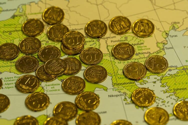 Photo by Q L: https://www.pexels.com/photo/golden-coins-on-map-background-29859663/