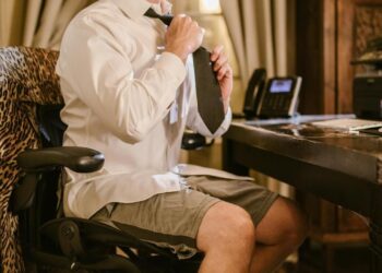Photo by RDNE Stock project: https://www.pexels.com/photo/a-man-in-white-long-sleeves-sitting-on-the-chair-while-fixing-his-necktie-6517305/