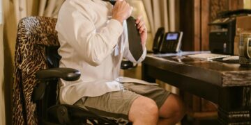 Photo by RDNE Stock project: https://www.pexels.com/photo/a-man-in-white-long-sleeves-sitting-on-the-chair-while-fixing-his-necktie-6517305/