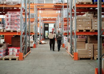 Photo by Tiger Lily: https://www.pexels.com/photo/workers-walking-along-aisle-in-warehouse-4487383/
