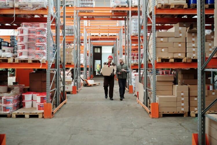 Photo by Tiger Lily: https://www.pexels.com/photo/workers-walking-along-aisle-in-warehouse-4487383/