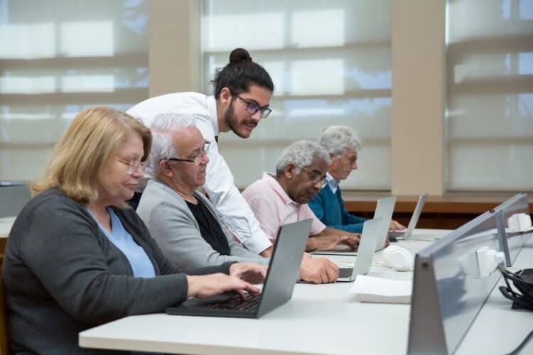 Photo by Kampus Production: https://www.pexels.com/photo/a-man-teach-a-group-of-elderly-to-use-a-laptop-7983552/
