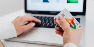 Photo by Photo By: Kaboompics.com: https://www.pexels.com/photo/close-up-shot-of-a-person-using-a-laptop-while-holding-a-credit-card-5717993/