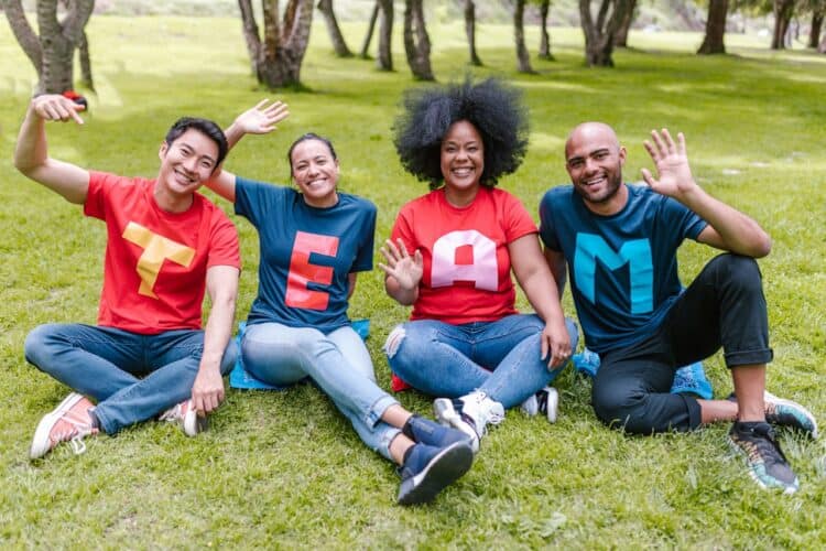 Photo by RDNE Stock project: https://www.pexels.com/photo/people-sitting-on-green-grass-waving-their-hands-7551760/