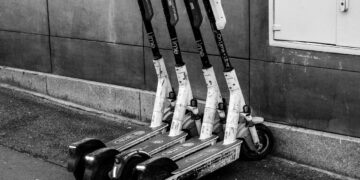 Photo by SHOX art: https://www.pexels.com/photo/black-and-white-image-of-parked-electric-scooters-34265538/
