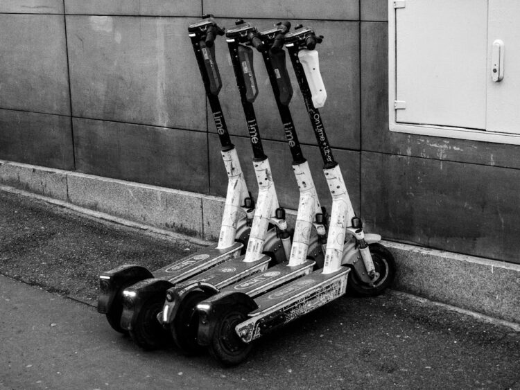 Photo by SHOX art: https://www.pexels.com/photo/black-and-white-image-of-parked-electric-scooters-34265538/