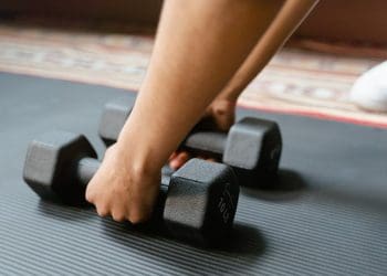 Photo by MART  PRODUCTION: https://www.pexels.com/photo/person-holding-black-dumbbells-8032759/