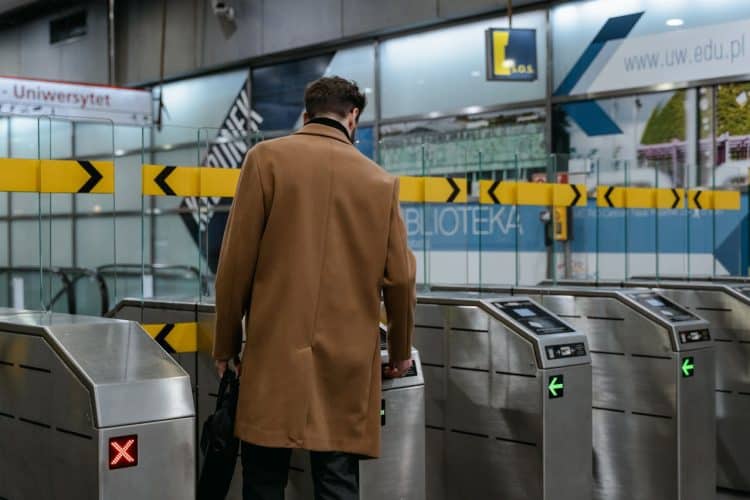 Photo by MART PRODUCTION from Pexels: https://www.pexels.com/photo/a-person-in-brown-coat-entering-a-subway-automated-ticket-barrier-7251095/