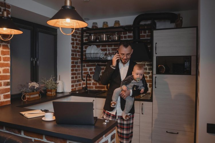 Photo by Tima Miroshnichenko from Pexels: https://www.pexels.com/photo/a-man-in-black-suit-jacket-carrying-baby-while-talking-on-phone-5725565/